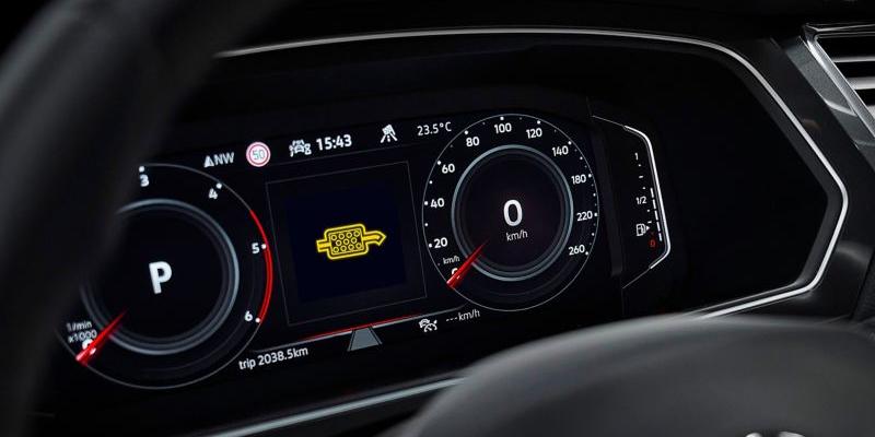 Close-up view of a car's digital dashboard displaying various information, including a warning light for the diesel particulate filter.