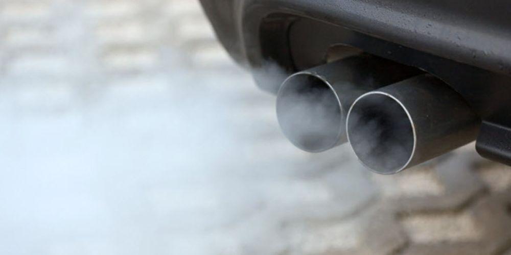 Exhaust pipes of a vehicle emitting white smoke, possibly indicating burning oil