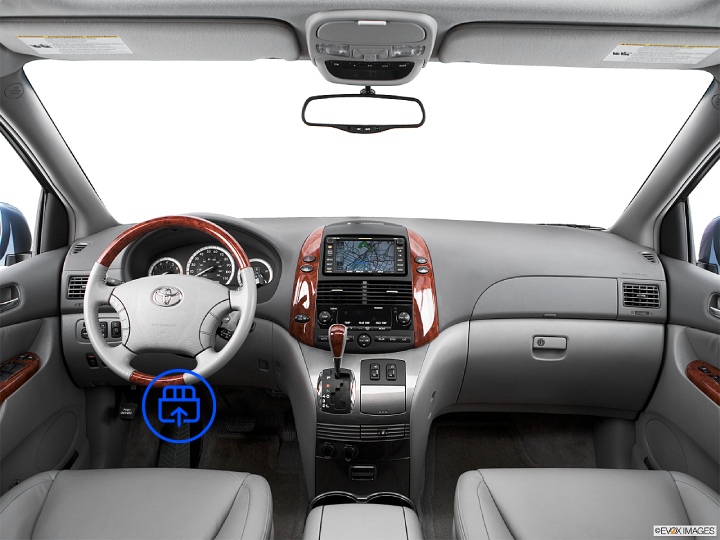 The image shows the interior of a Toyota Sienna, highlighting the OBD-II port location beneath the dashboard near the driver’s footwell.