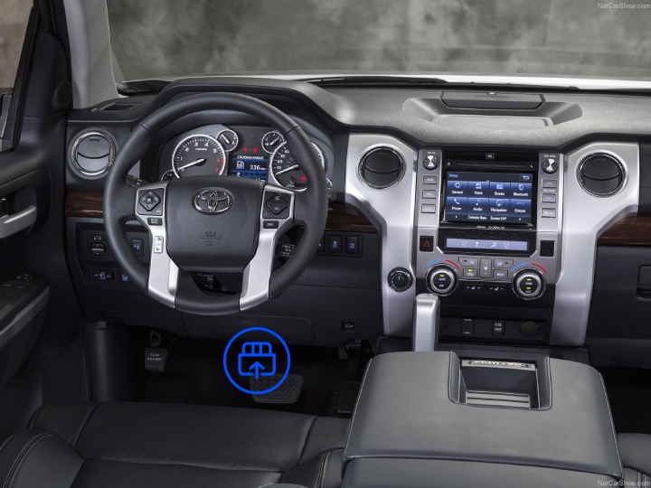  The image shows the interior of a Toyota Tundra, highlighting the OBD-II port location beneath the dashboard near the driver’s footwell.